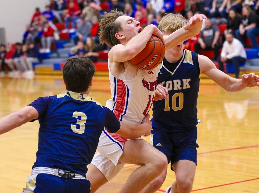 Aidan McDowell of Crete fights through the York defense and is fouled on Feb. 27.