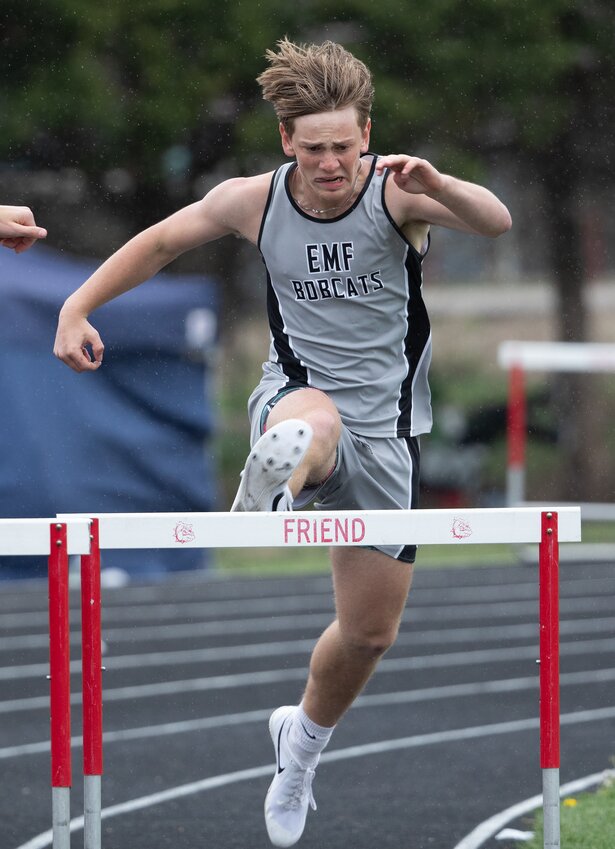 EMF's Tyler Due goes over a hurdle in the 300-meter hurdles at the track meet in Friend April 16.