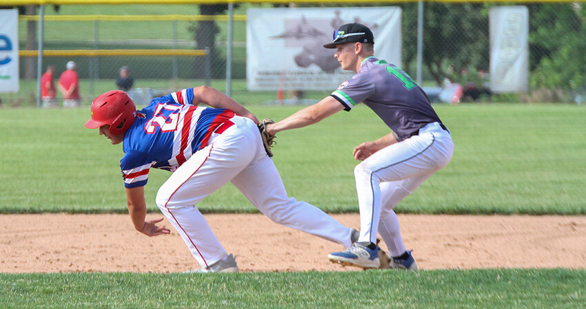 Seward's Quin Berner tags out Zack Connell of Crete in a rundown June 19.