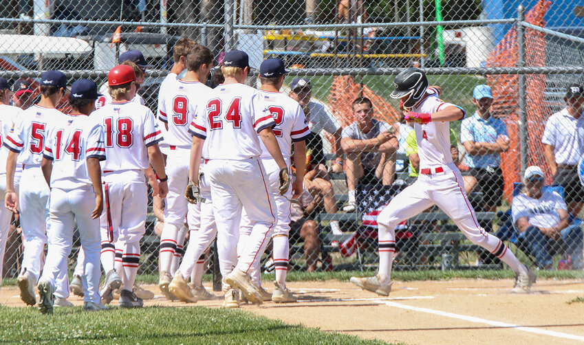 Trevor Roach of the Cornerstone Bank (Geneva) Sharks steps on home plate before celebrating his home run with his teammates June 29.