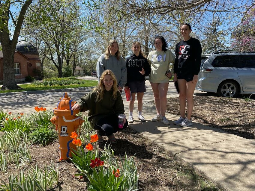 Doane University art students Olivia Kuzas, Kendall Meyer, Brooklyn Mercurio, Madi Schneider and Jadyn Branson were involved in a project painting the campus fire hydrants. Not pictured is Lizzi Sand.