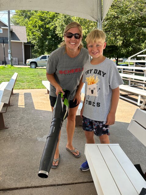 Jamie Brueggemann & Charles Koll help clean up the outdoor theater seating.