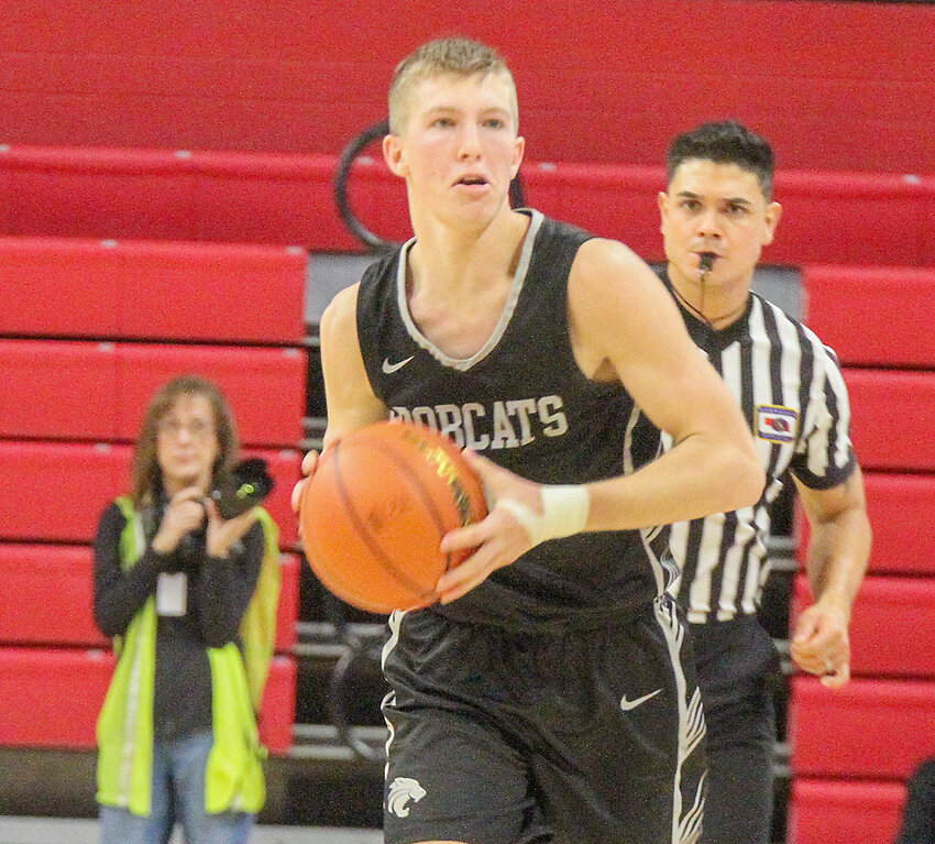 Carter Milton looks for an open teammate down the court.