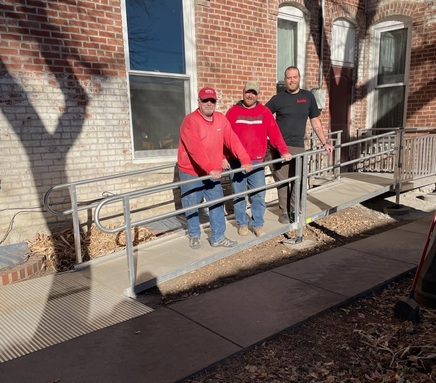 Hotel Wilber installed a new ADA-compliant handicap entrance ramp on Dec. 10. Pictured are, from left, Joe Gifford, Barry Young and Austin Seyfert.