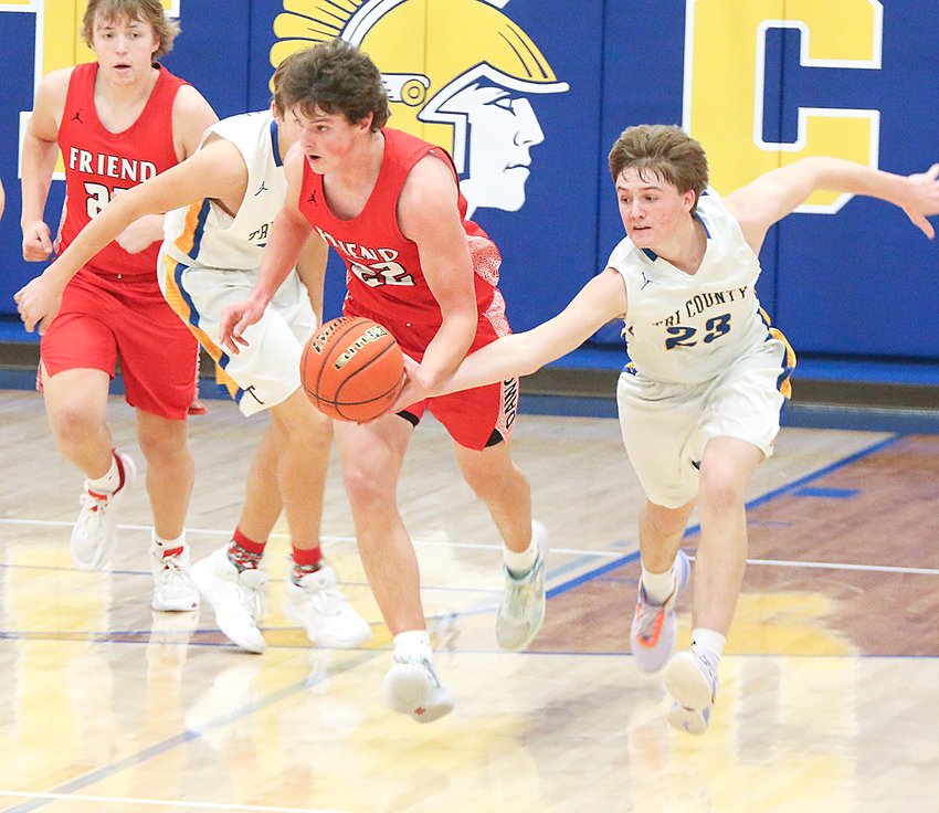 Friend's Jacob Klooz heads downcourt with the ball as Colton Bales of Tri County reaches in for a steal Jan. 3.