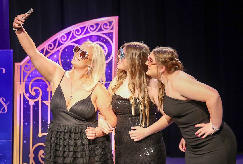 Elli Bengtsson, left, Ashlyn Zoubek and Kira Jonas stop on stage and pose for a selfie during Wilber-Clatonia's prom on April 22. See more prom photos on page 8.
