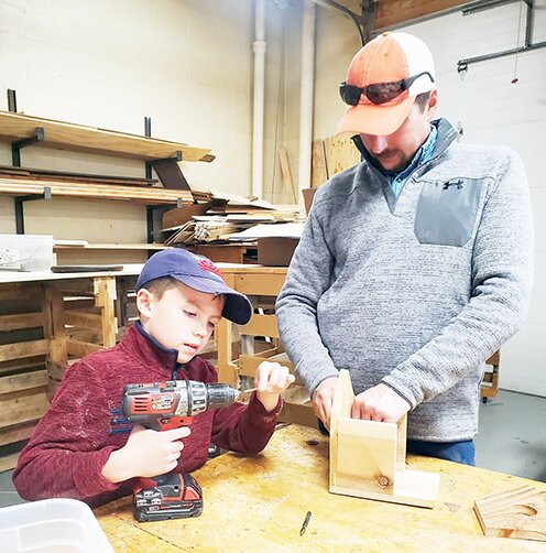 Korbin Kunc and his dad, Jake, work together on constructing a birdhouse on April 23 as part of a woodworking workshop hosted for Saline County 4-H and Clover Kids.