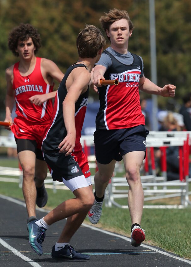 Friend's Christian Conley hands the baton off to Mason Vossler in the 3200-meter relay.