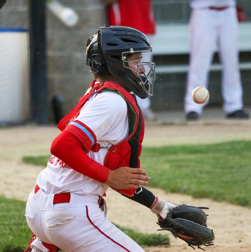 Nick Wendt of Crete Stop 'N Shop Seniors loses sight of the pitch after the Seward batter makes contact on June 6.