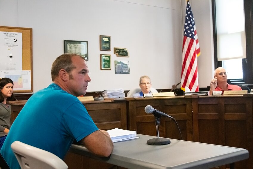Jeff Koll, a member of both Planning and Zoning and the Board of Adjustment, explains Planning and Zonings proposed regulation changes for wind and solar energy to the Board of Commissioners on Aug. 22 during a public hearing. The regulations failed in a vote.