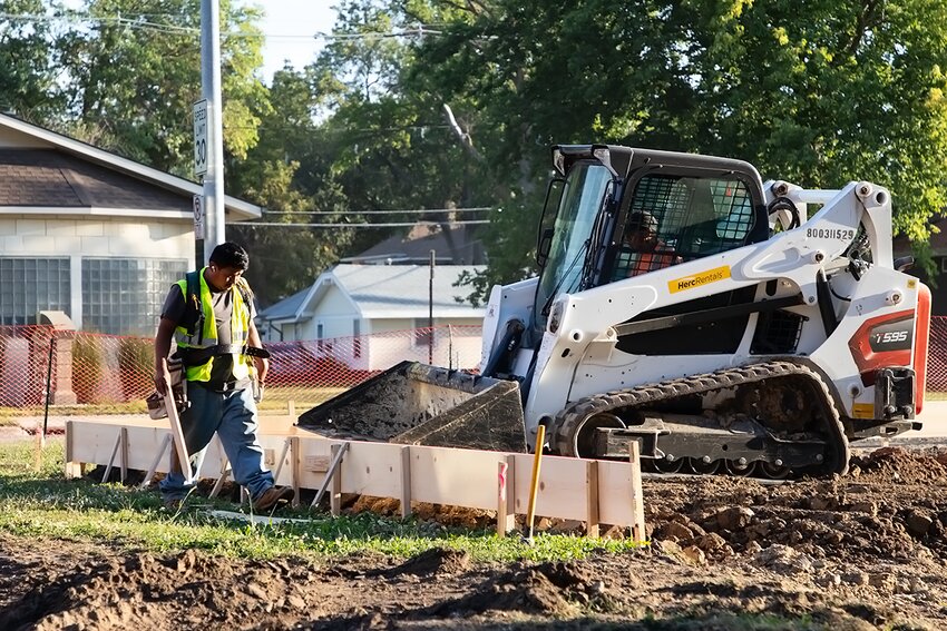 Construction workers reroute traffic adjacent to City Hall and prepare for concrete work on Sept. 19. The project is to make room for an ADA playground expansion to City Park.