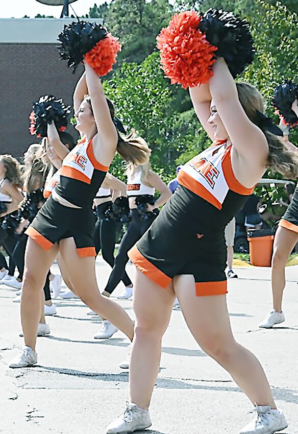 Doane cheerleaders perform during the Homecoming tailgate while the Doane pep band, featuring alumni, play game day music during activities Sept. 30 on the campus.