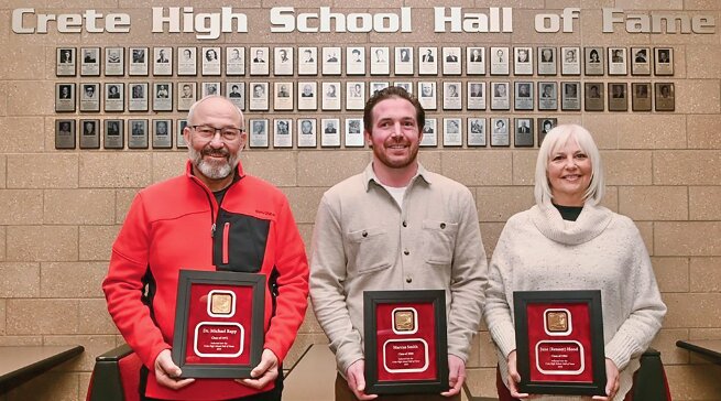 Crete inducted its Hall of Fame class on Jan. 20 during halftime of the boys&rsquo; basketball game against Elkhorn. Pictured are, from left, Michael Rapp, Marcus Smith and Connie Hood (filling in for Jane Hood).