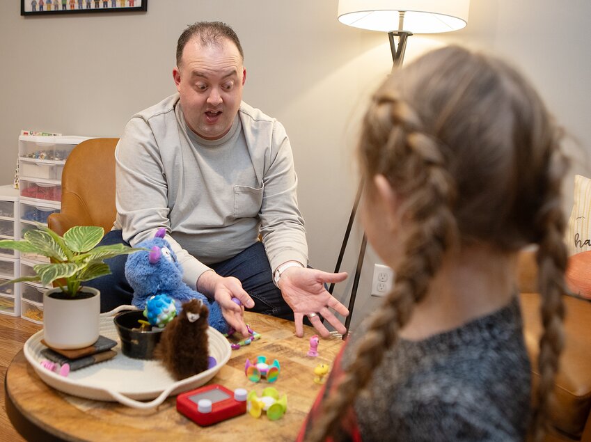 Crete play therapist Ben Piper demonstrates how when children have a fidget toy they are better able to express thoughts and feelings. The child in the above photograph is a model and is not a patient. All patients are confidential.