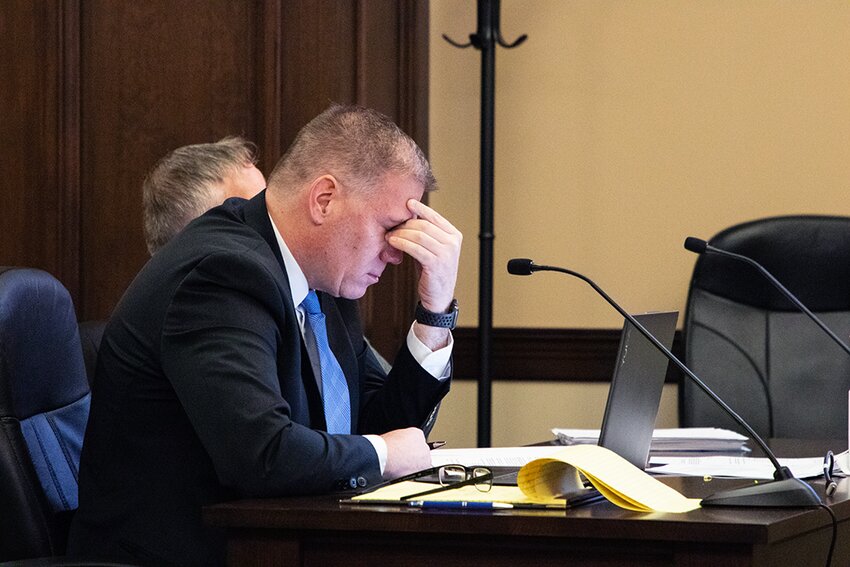 Jonathan Bratten, attorney for Matthew Hoffman of Dorchester, pinches the bridge of his nose while listening to testimony from a forensic accountant that credits $22,032.56 in theft charges to Hoffman. The March 14 hearing in county court ruled the State met its burden of proof to move forward with felony charges in district court. Hoffman will appear again in district court on April 3.
