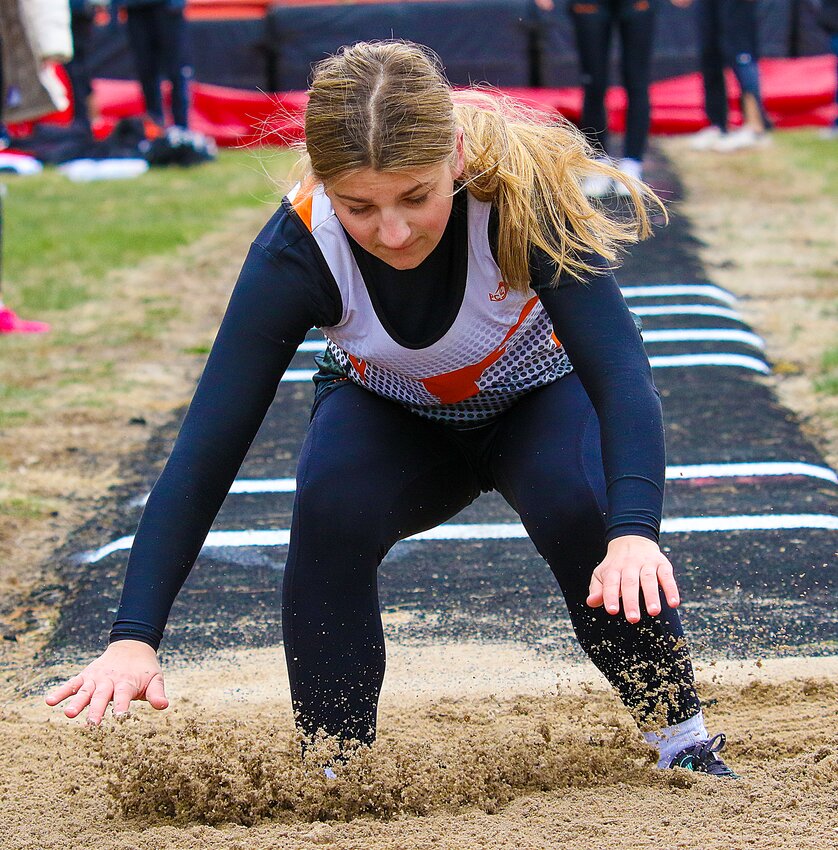 Gabby Theis of Dorchester braces for impact as she lands in the long jump pit during the Friend Turkey Creek relays on March 27.