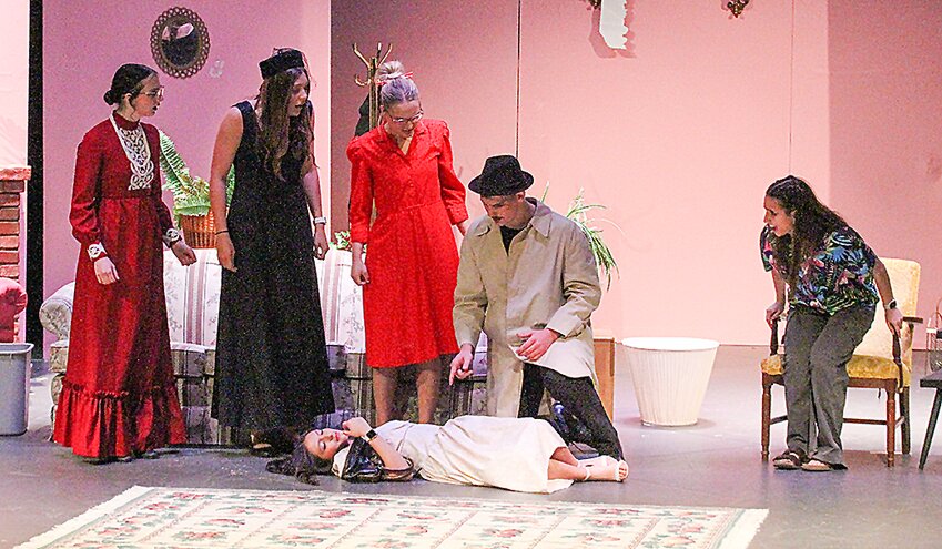 Bridget Moriarty (Jessica Martinez) lies dead as Rebecca Fitzwilliam (Lillian Korbel), Fay Strange (Madison Vogel), Anguish Crispie (Delaney Mazza) and Marie Palegrave (Lena Eschiti) wait for Hercules Porridge (Stone Thelen) to determine her cause of death in “The Crimson House Murder.” The play will be performed by the Wilber-Clatonia senior class Saturday, April 20, at 7 p.m. and Sunday, April 21, at 4 p.m.