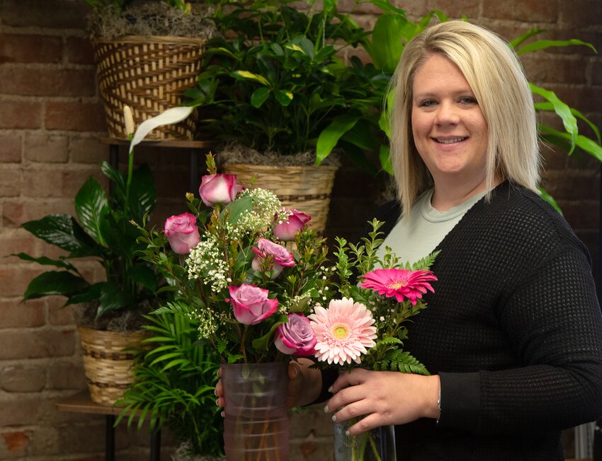 Chelsey Myers with Wilber Floral poses with some of the store's flowers.
