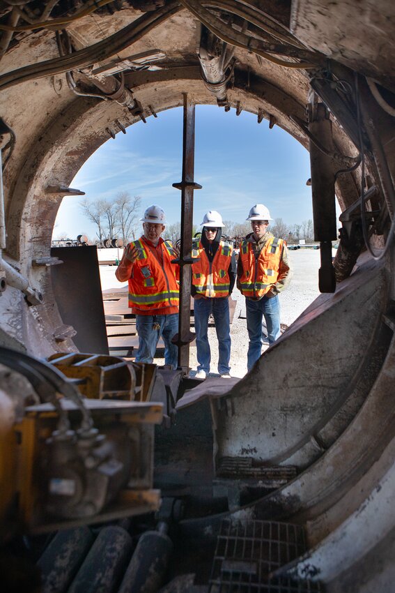 Lonnie Shoup,  safety director and human resource manager for Horizontal Boring & Tunneling Co. in Exeter, discusses one of the company's boring machines with Friend School students Jake Leif and Jordan Lawver during the company's 
