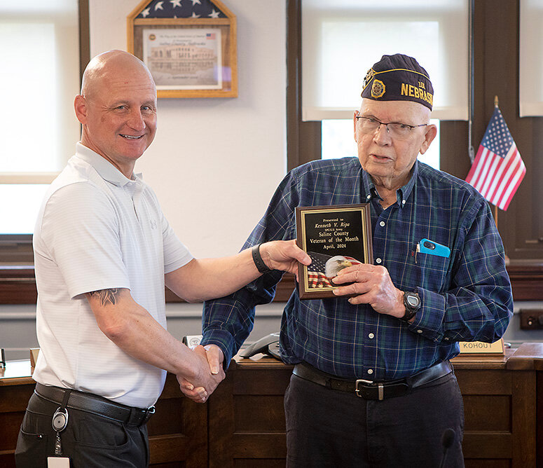 Kenny Ripa of Wilber accepts the April 2024 Saline County Veteran of the Month award from Scott Davis, Saline County Veterans Services Officer at the county commissioners meeting April 30.