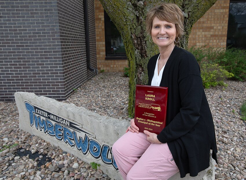 Exeter-Milligan principal Laura Kroll poses with the award she recently won.
