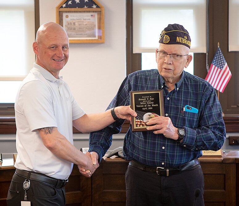 Kenny Ripa of Wilber accepts the April 2024 Saline County Veteran of the Month award from Scott Davis, Saline County Veterans Services Officer, at the county commissioners meeting April 30.