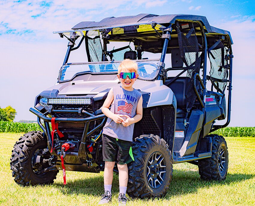 Five-year-old Rhett Hoglund of Hickman was delighted to drive fast through the fields of Clatonia during Clatonia Rescue’s new ATV ride event during Clatonia Days.