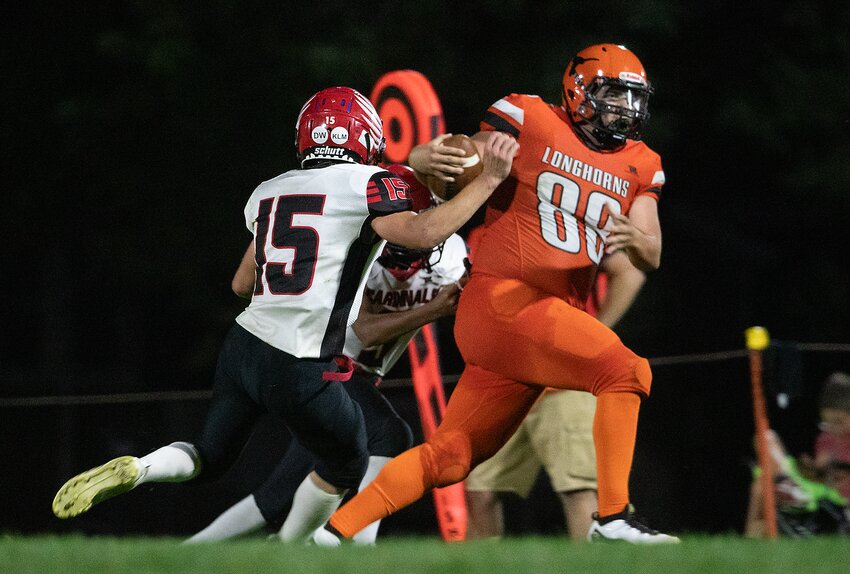 Dorchester's Owen Vyhnalek returns his interception after Dorchester's Chase Tachovsky pressures the Harvard quarterback during the Longhorns' 58-12 victory Sept. 27.