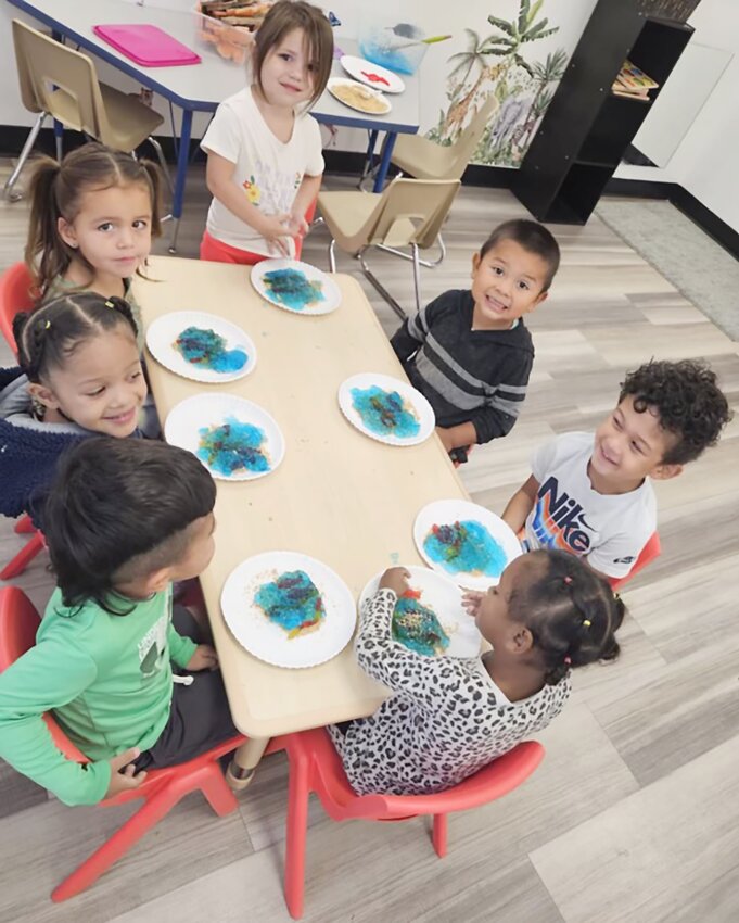 Dexter Kavaz, America Andersen, Olivia Winchel-Christensen, Brooklyn Heller, Diego Alvarez Garcia, Bently Bramble and Lyndia Weaver learn in a group at Kathy’s Cardinal Kids Learning Center.