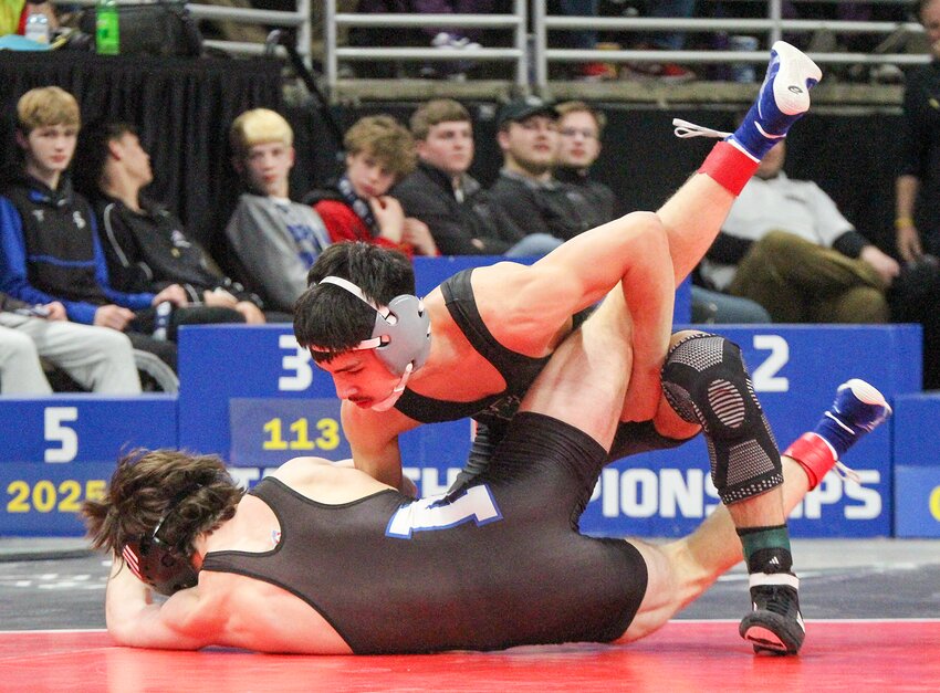 Zaiyahn Ornelas of Wilber-Clatonia takes down Yair Santiago of Norfolk Catholic during their semifinal match. Ornelas finished as the Class C 120-pound champion.
