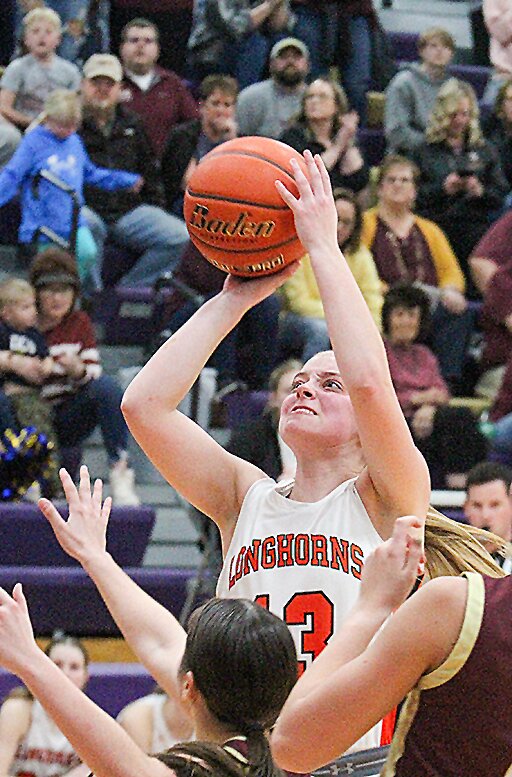 The Dorchester bench, from left, Kendall Kasl, Savannah June, Faith Elkins, Hadley Brandt and Micaela Loarca watch their teammates on the court against Dundy County Stratton Feb. 28.