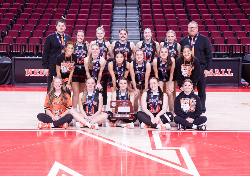 Bailey and Gabby Theis, Liv Schweitzer and Lily Lehr hug one last time as Longhorn teammates after the state championship game on March 8.