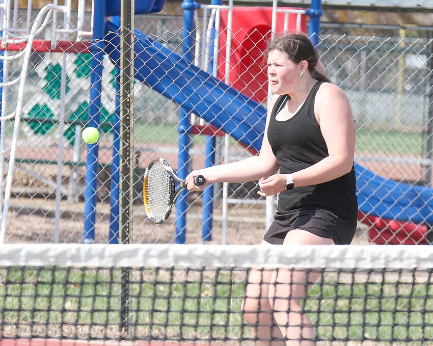Ashley Milla Lujan of Wilber-Clatonia reaches for a return during a doubles match against Beatrice April 8 in Wilber.
