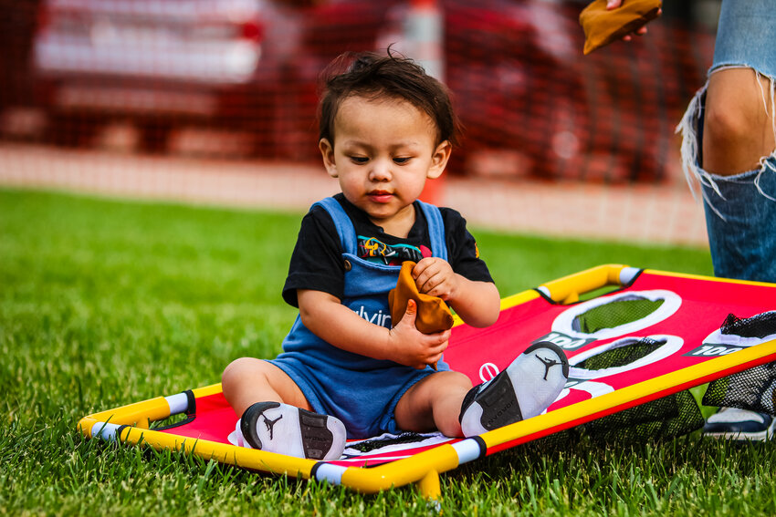 Herman Vicente, 16 months, has the bean bag toss figured out. Activities at the Sixpence Summer Bash included yard games, bubbles, a bounce house, balloon animals, face painting and table activities for busy hands - like MagnaTiles. Participating families were able to build connections while enjoying a meal together.