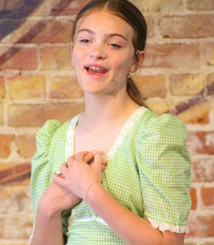Braylee Davenport sings a solo during the Friend Kids Theatre performance on June 6. The show was "Celebrating musical theatre set in America’s roots!" Which included inspiration from musicals such as Annie Get Your Gun, State Fair, Oklahoma, Crazy For You, Wizard Of Oz, Music Man and Big River.