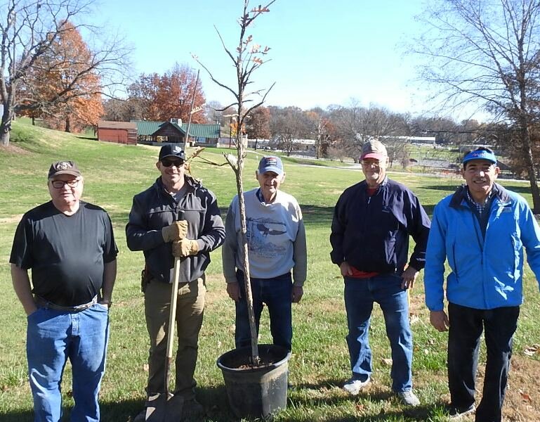 Rotary President Greg Stidham, Arborist Dakota Wells, and members Roger Lembke, Kurt Rohr, and Erik Martinez, plant a bur oak tree in the Fayette City Park.
