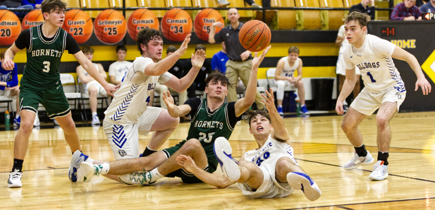 Going after a loose ball are New Franklin's Connor Wilmsmeyer (left) and Drake Clark (on the floor), and Westran's Marshall Kitchen (center).