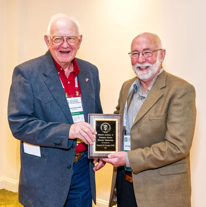 Dr. Vroman (left) accepts the MVMA Academy Distinguished Service Award from Dr. Mac Wilt at the Missouri Veterinary Medical Association’s annual convention in January.