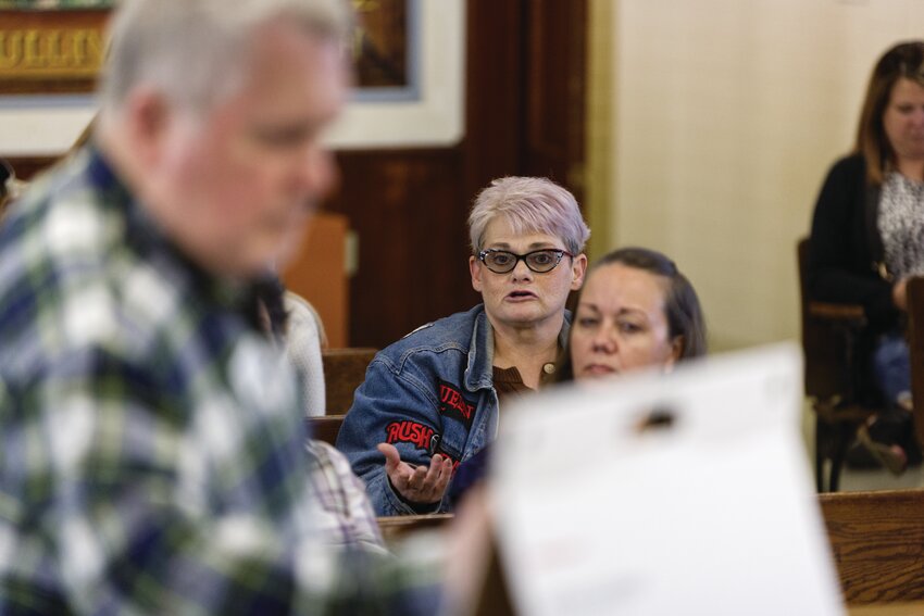 Downtown business owner Mickie Foland expresses her opposition to proposed parallel parking on North Main Street during a public forum hosted by the Fayette city council on Thursday. Forum moderator, Jim Fram (in foreground), took notes and drafted a report for the city.