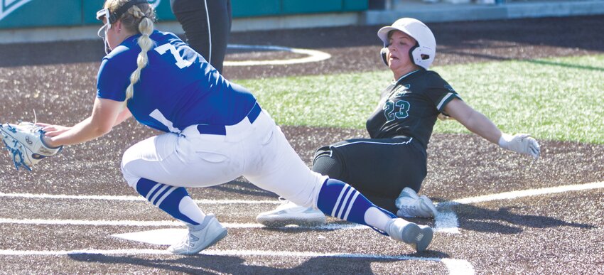CMU sophomore Elizabeth Palumbo slides into home plate on a wild pitch in the bottom of the second.