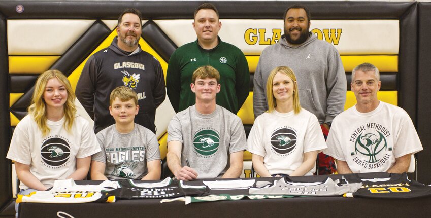 Glasgow senior Jordan Fuemmeler signed his letter of intent to play basketball at Central Methodist next season. Seated left to right: Halle, Cade, Jordan, Theresa, and Jamey Fuemmeler. Standing: Glasgow coach Mick Cropp, CMU coach Matt Sherman, and Glasgow assistant Spencer Gerald.