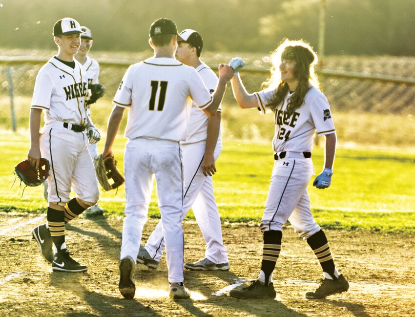 Higbee seniors Micah Kirby (right) and Derek Rockett fist bump after winning the season opener against Fayette in March. On Friday, both hit doubles in a one-run victory over district rival Cairo.