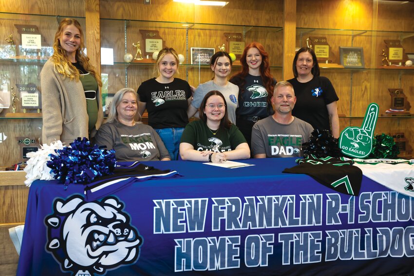 New Franklin senior Gracie Martin signed her letter of intent to be a member of the cheerleading squad at Central Methodist University in the fall. 
Seated: Gracie Martin and her parents, Christy and Anthony Martin. Standing, left to right: New Franklin cheer coach Blakeley Elliott, CMU cheerleader Jasmine Stewart, sister Makenzie Martin, CMU assistant cheer coach Abigail Rosa, and New Franklin dance coach Stacy Wells.