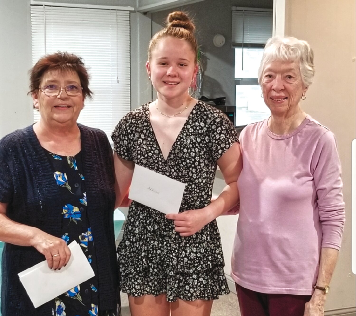 Golden Study Club members Ronda Gerlt (left) and Pansy Kean (right) present a $600 scholarship to recent FHS graduate Addison Newell (center).