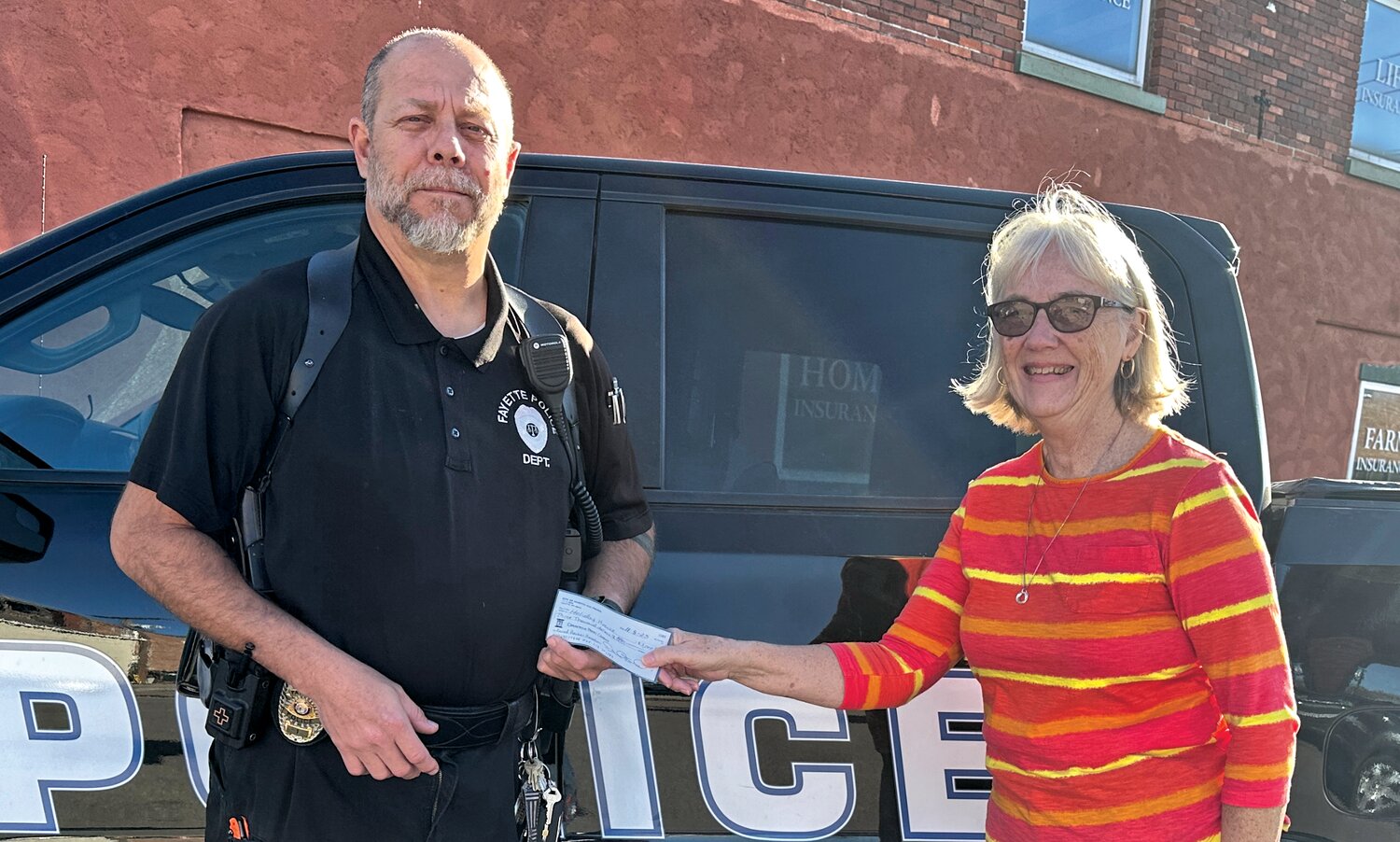 Fayette City Marshal David Ford handed a check in the amount of $3,000 to Pat Hilgedick with the Holiday House. The funds were raised at the annual department’s Pork Steak Fundraiser held on Sunday, Nov. 11.