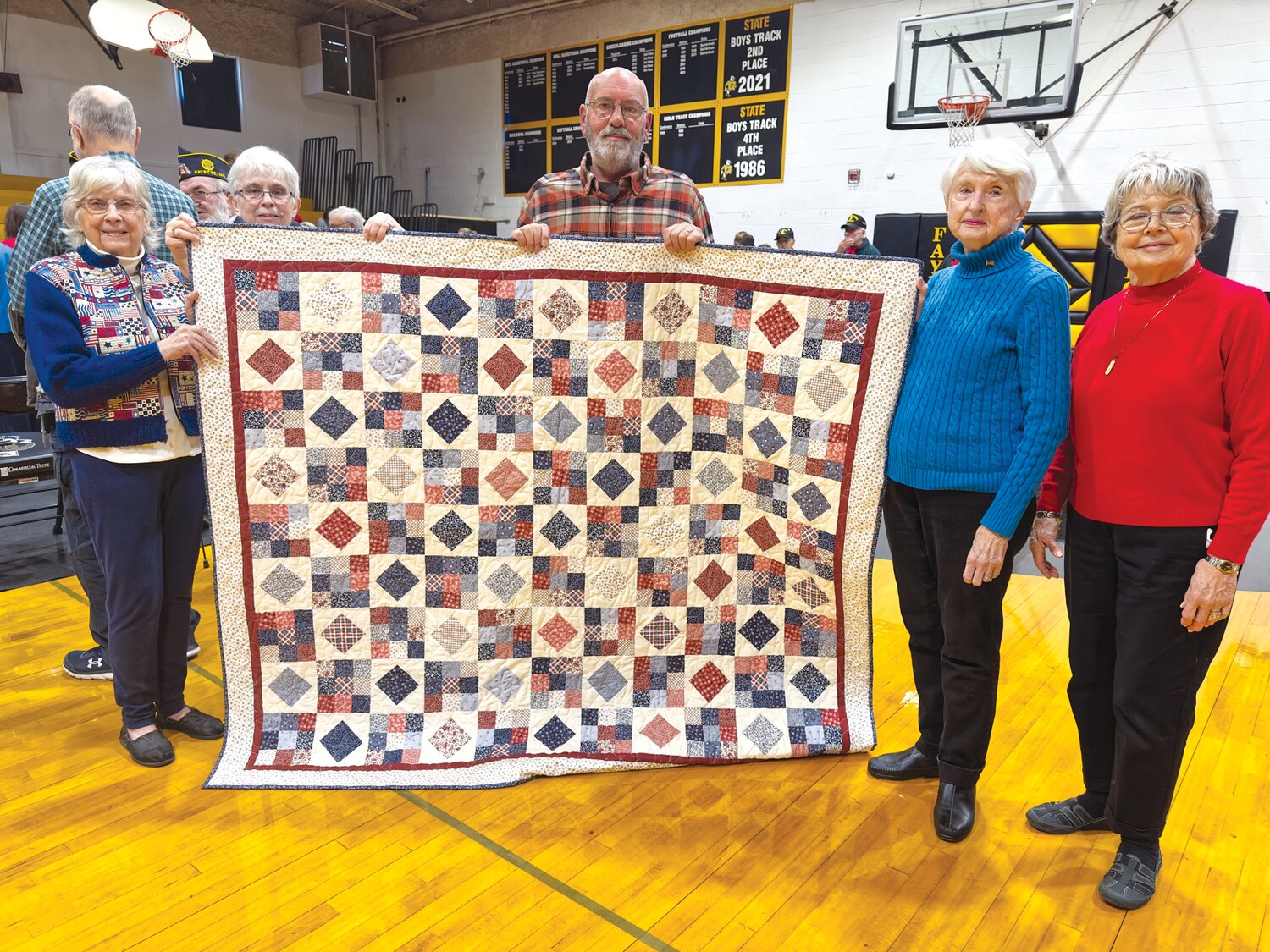 Veteran Kavin Owings received the Quilt of Valor Friday from the Peacemakers Quilters. Left to right: Connie Shay, Linda Lembke, Owings, Dorothy Ayers, and Jill Rohr. Not pictured: quilter Julie Menees.