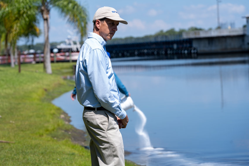 ALVA -- A product called Lake Guard Oxy was spread from the shoreline by hand and out in the river by boat to control a blue-green algae bloom in the Caloosahatchee River on May 27.