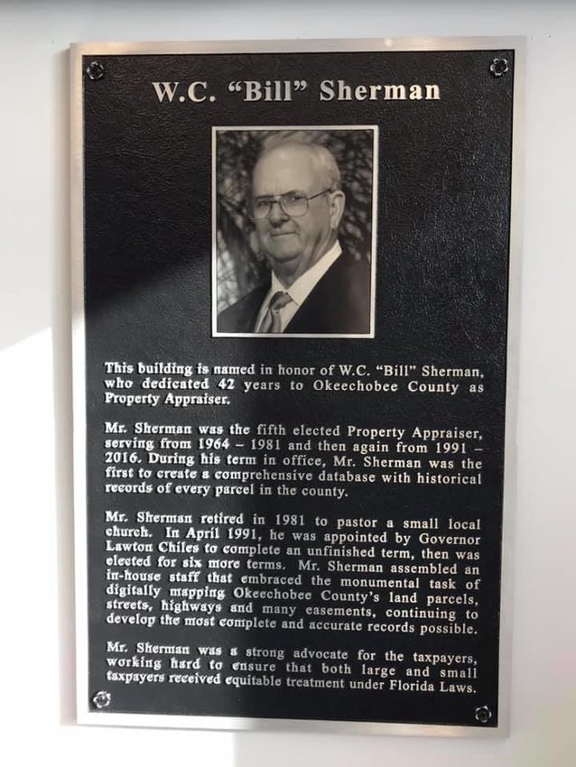 A plaque honors W. C. "Bill" Sherman who served Okeechobee County Property Appraiser's office for 47 years.