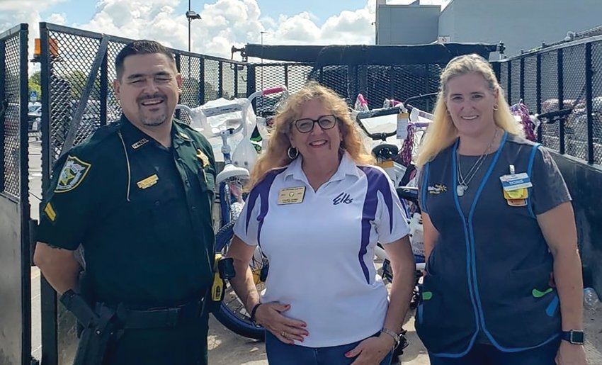 Cheryl Gumz (center) on behalf of the Elks' Club presents 10 new bikes to the Okeechobee County Sheriff's office to be given away during their upcoming health expo.
Cpl. Jack Nash and  Doris Rosales are pictured with her.