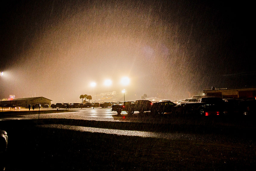 Rain pours down at Okeechobee High School before the Brahman game against Frostproof.